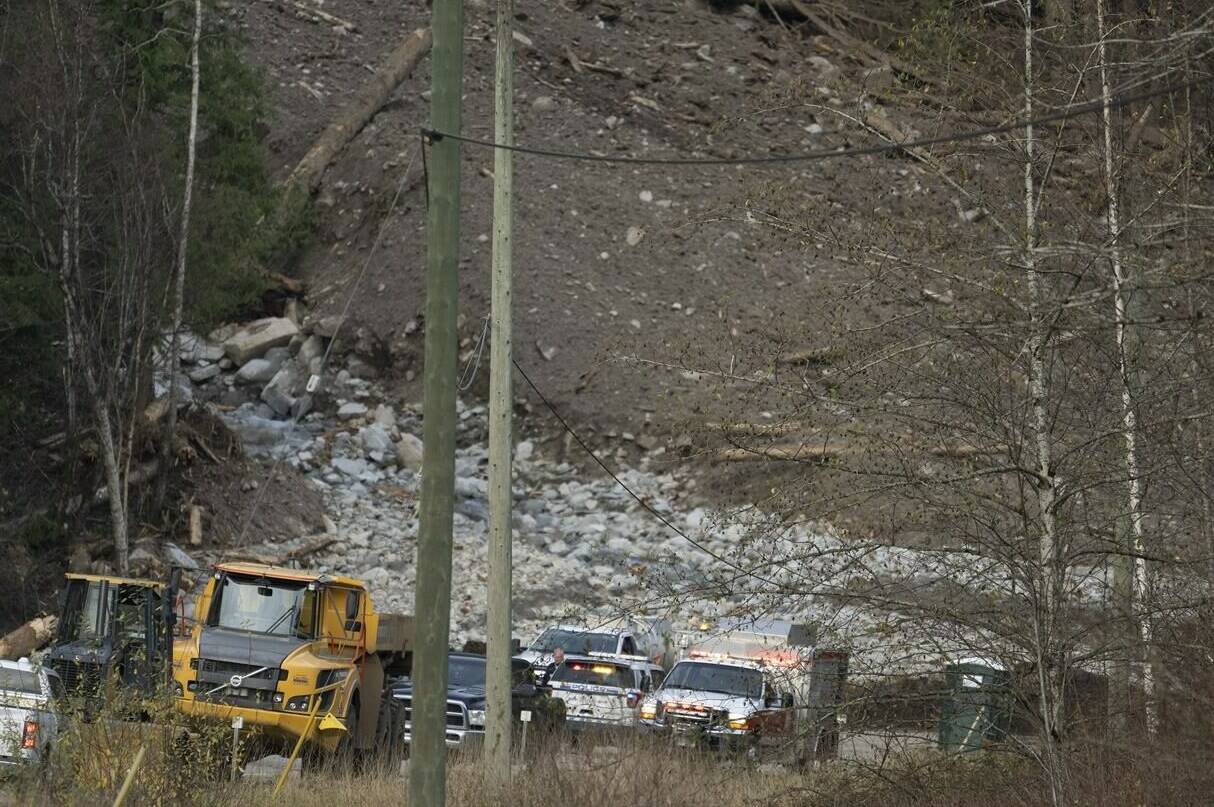 Emergency vehicles and tractors are seen at the base of a mudslide on Highway 7 west of Agassiz, B.C., Wednesday, Nov. 17, 2021. THE CANADIAN PRESS/Jonathan Hayward