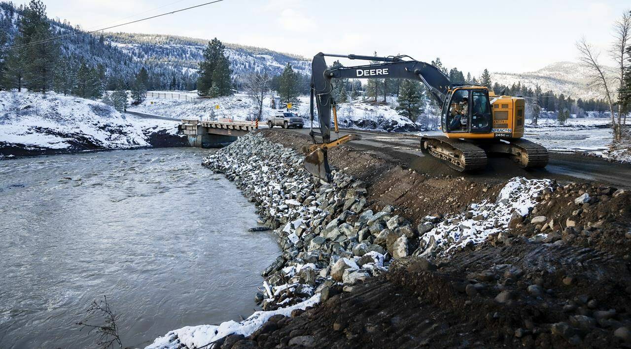 Construction crews work to build a bridge for the Nooaitch First Nation near Merritt, B.C., which has been completely cut off by flooding on, Friday, Nov. 19, 2021.THE CANADIAN PRESS/Jeff McIntosh