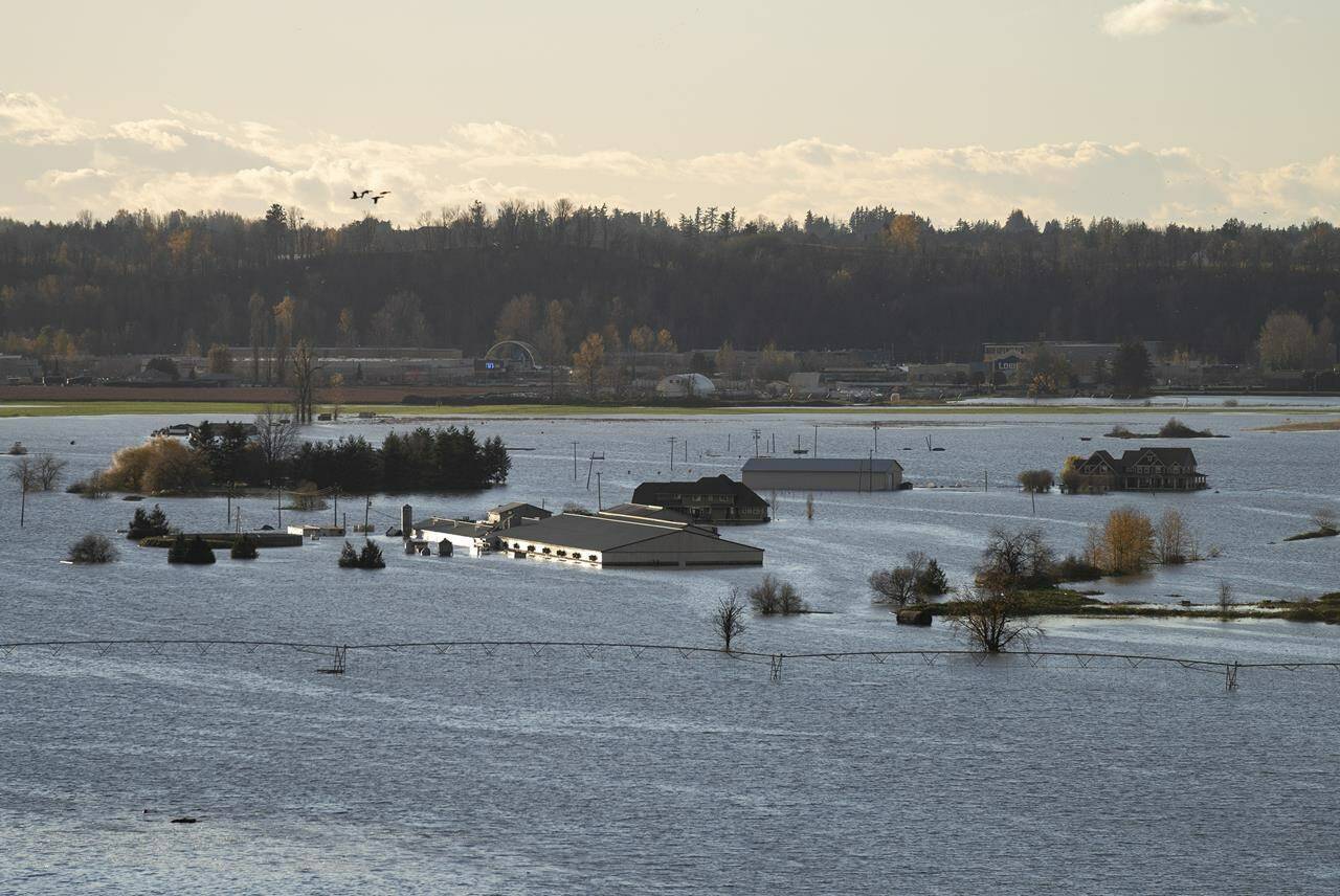 Rising flood waters surround buildings in Abbotsford, B.C., Tuesday, Nov. 16, 2021. THE CANADIAN PRESS/Jonathan Hayward