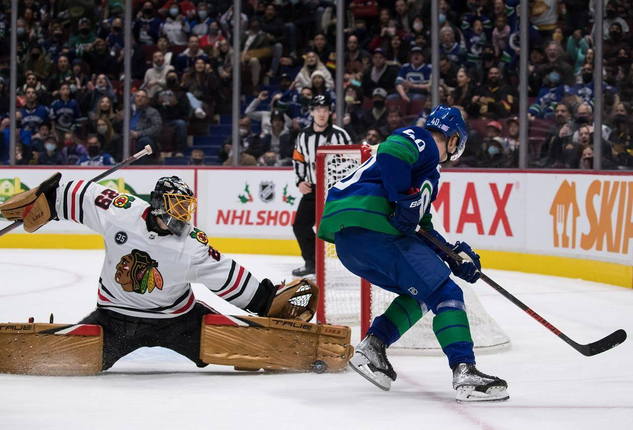 Chicago Blackhawks goalie Marc-Andre Fleury, left, stops Vancouver Canucks’ Elias Pettersson, of Sweden, during second period NHL hockey action in Vancouver, B.C., Sunday, Nov. 21, 2021. THE CANADIAN PRESS/Darryl Dyck
