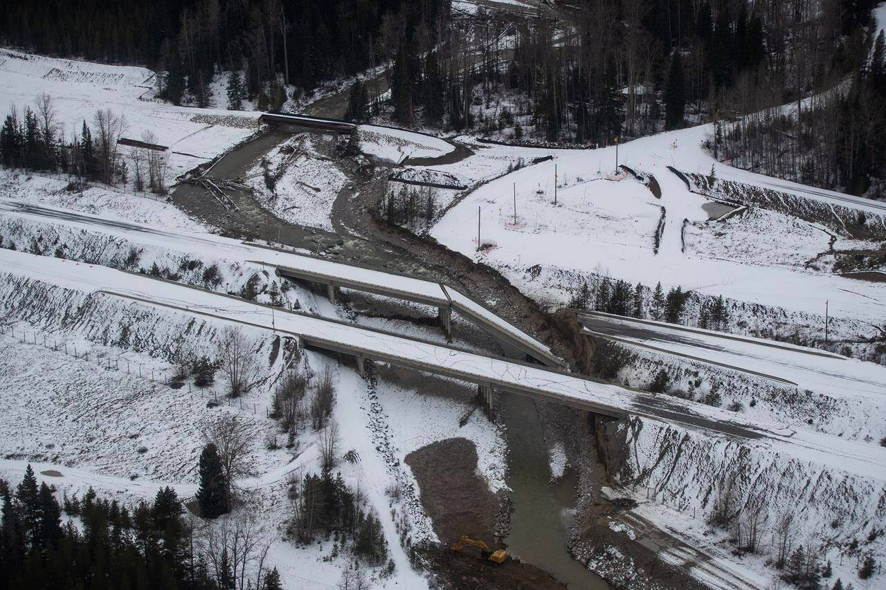 A collapsed section of a bridge sits in the water after severe flooding and landslides on the Coquihalla Highway south of Merritt, B.C., as seen in an aerial view from a Canadian Forces reconnaissance flight on Monday, November 22, 2021. THE CANADIAN PRESS/Darryl Dyck