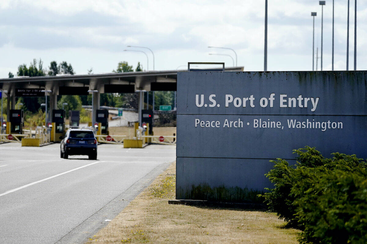 A single vehicle heads into the U.S. at the quiet Peace Arch border crossing Monday, Aug. 9, 2021, in Blaine, Wash. (AP Photo/Elaine Thompson)