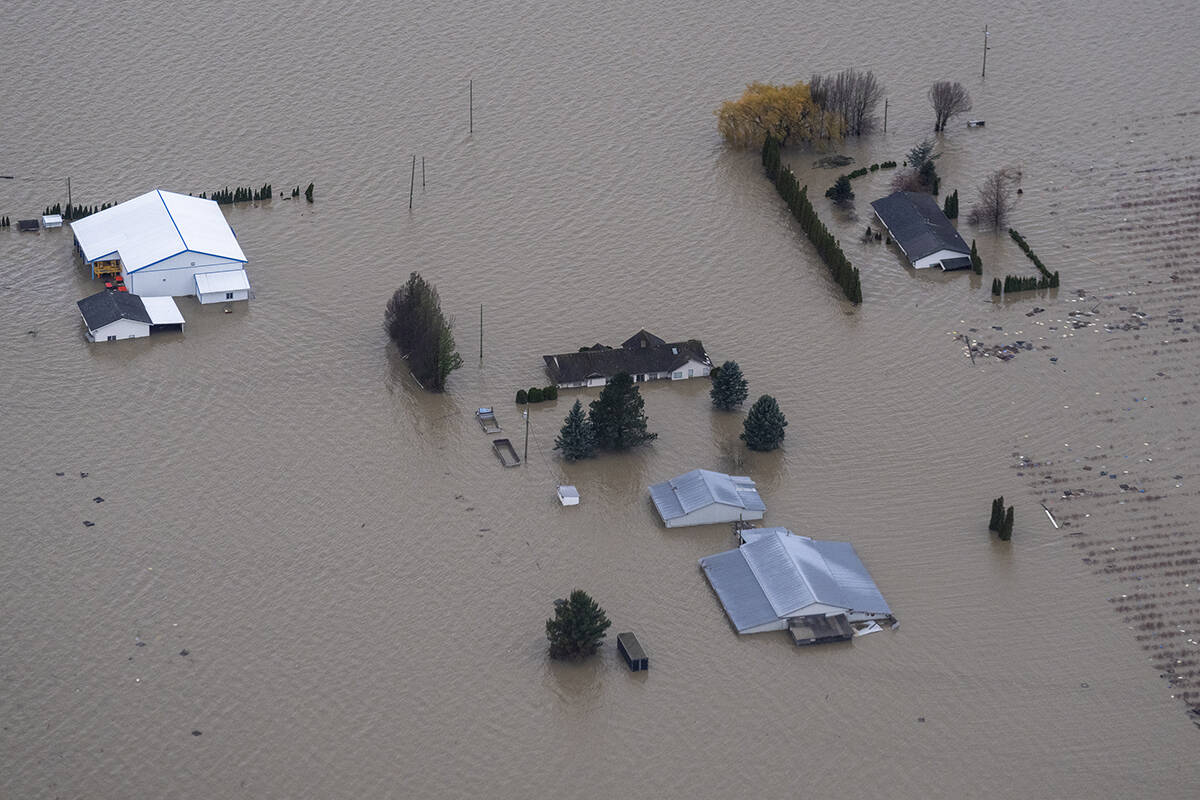A farm is surrounded by flood waster as seen from a fly over of the flood damage in Abbotsford, B.C., Tuesday, November 23, 2021. THE CANADIAN PRESS/Jonathan Hayward