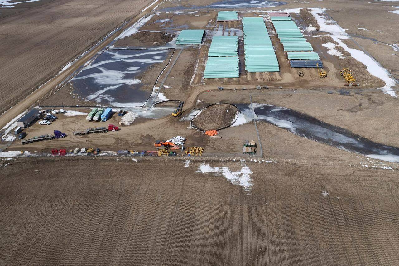 In this April 13, 2020, photo provided by TC Energy, a pipe storage yard with material for construction of the Keystone XL oil pipeline is seen at a staging area along the U.S.-Canada border north of Glasgow, Mont. THE CANADIAN PRESS/HO-TC Energy via AP