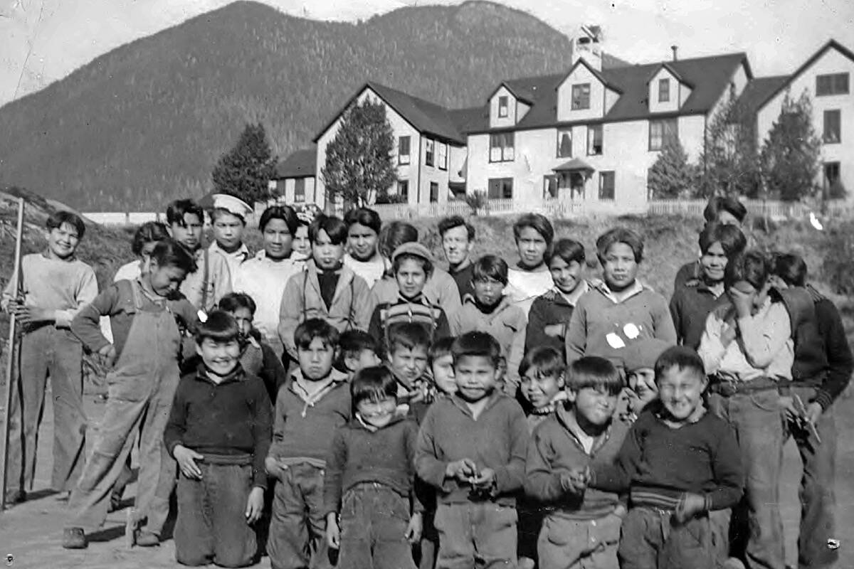 In this old photo from the Archives Deschâtelets-NDC, Fonds Deschâtelets, children gather in front of the old Christie Residential School on Meares Island off the west coast of Vancouver Island near Tofino. The date the photo was taken is unknown.