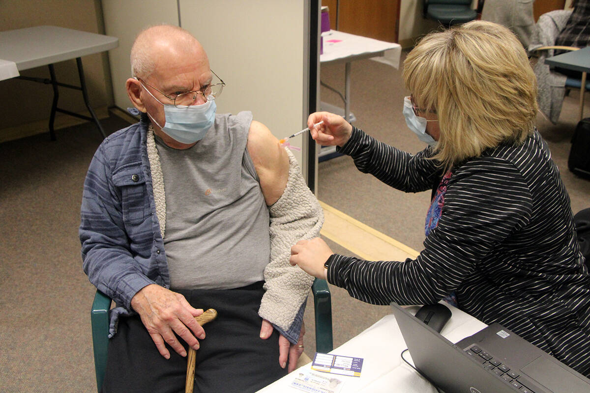 Ralph Cole receives his first COVID-19 vaccination the South Cariboo Health Centre, March 2021. B.C. residents aged 70 and older are currently getting booster third doses, as their immunity is less than younger people. (Patrick Davies/100 Mile Free Press)