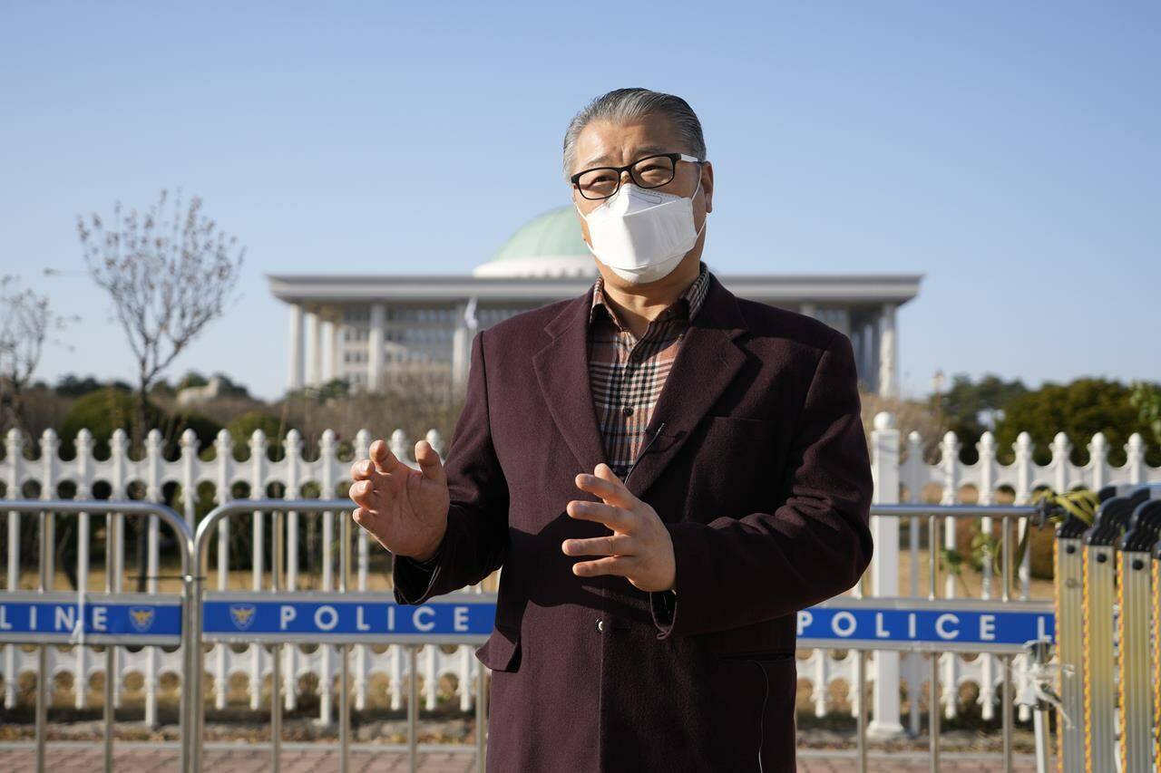 Ju Yeongbong, secretary general for an association of dog farmers, speaks during an interview in front of the National Assembly in Seoul, South Korea, Thursday, Nov. 25, 2021. South Korea on Thursday said it’ll launch a task force to consider outlawing dog meat consumption, about two months after the country’s president offered to look into ending the centuries-old eating practice. (AP Photo/Lee Jin-man)