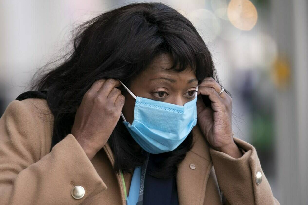 Newly elected Conservative MP Leslyn Lewis adjusts her mask as she arrives for the first party caucus since the federal election, in Ottawa, Tuesday, Oct. 5, 2021. THE CANADIAN PRESS/Adrian Wyld