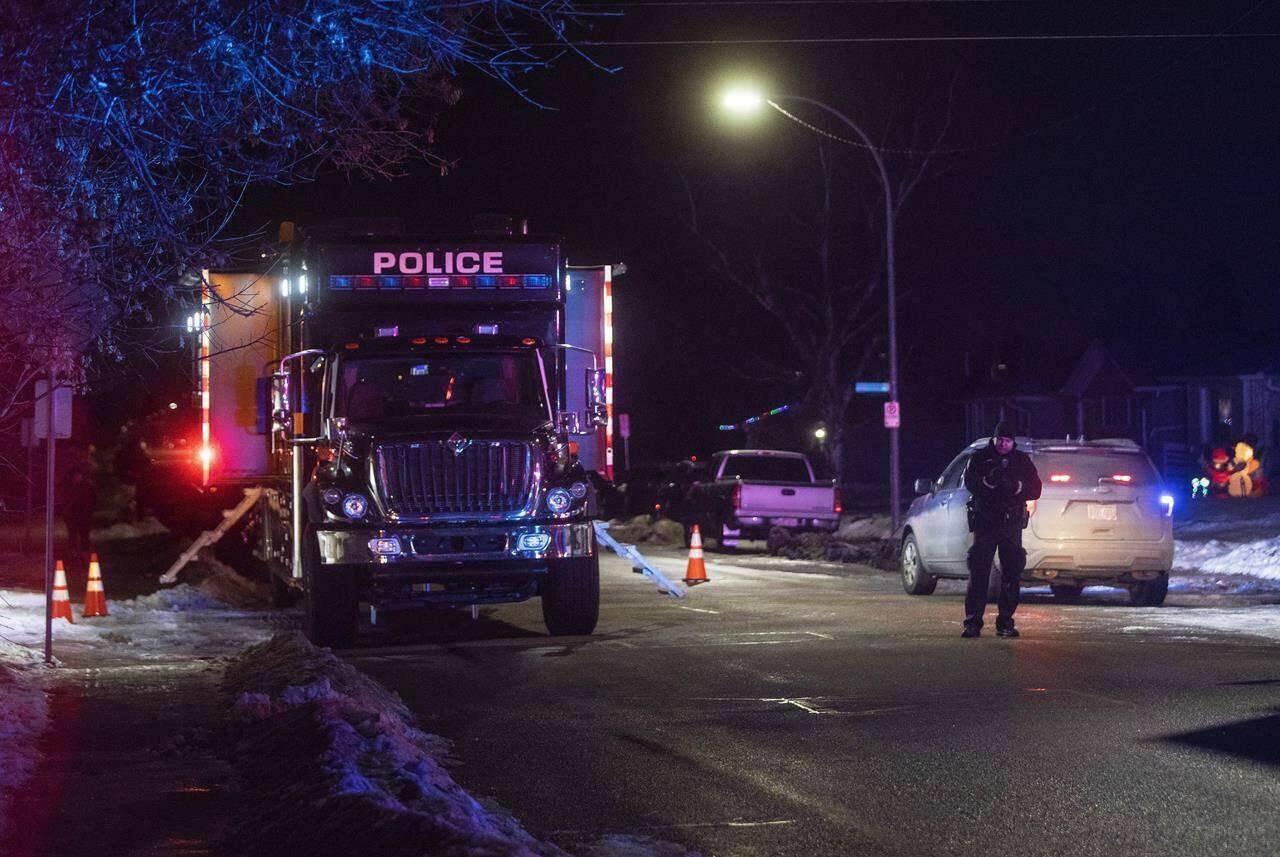 Police secure the scene where they allege a suspected bank robber fled to a residential area and took hostages in Edmonton, Alta., Monday, Nov. 29, 2021. THE CANADIAN PRESS/Jason Franson
