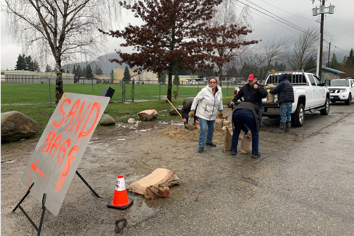 Residents of Riverview Drive in Hope fill sandbags on Nov. 29, 2021, one day before the District of Hope issued an evacuation alert for 114 homes on the Coquihalla River. (Jessica Peters/ Hope Standard)