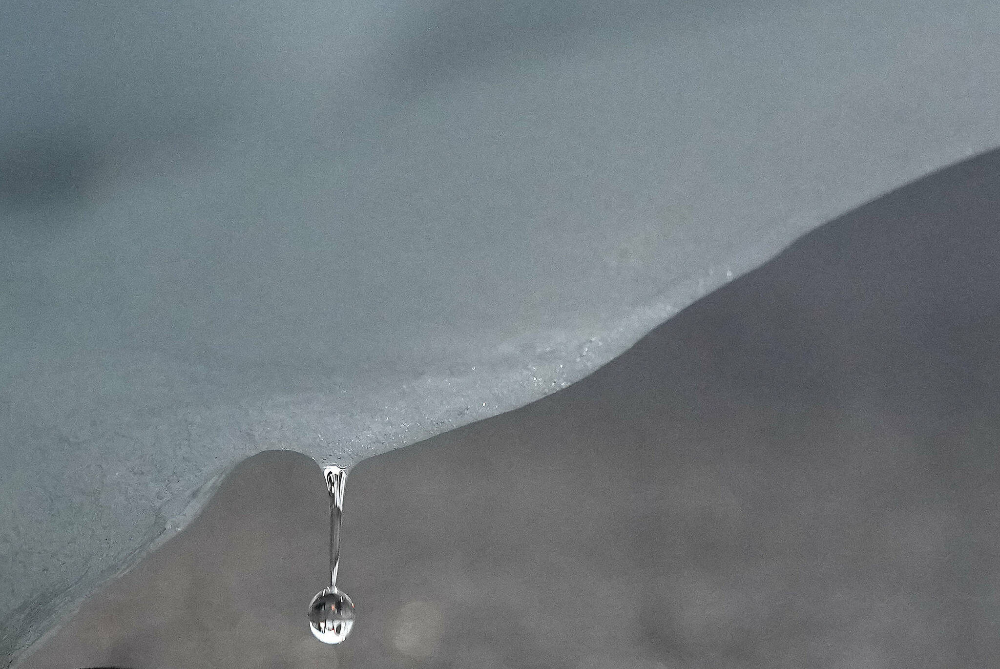 A droplet of water falls from an iceberg delivered by members of Arctic Basecamp is placed on show near the COP26 U.N. Climate Summit in Glasgow, Scotland, Friday, Nov. 5, 2021. The four ton block of ice, originally part of a larger glacier, was brought from Greenland to Glasgow by climate scientists from Arctic Basecamp as a statement to world leaders of the scale of the climate crisis and a visible reminder of what Arctic warming means for the planet. (AP Photo/Alastair Grant)