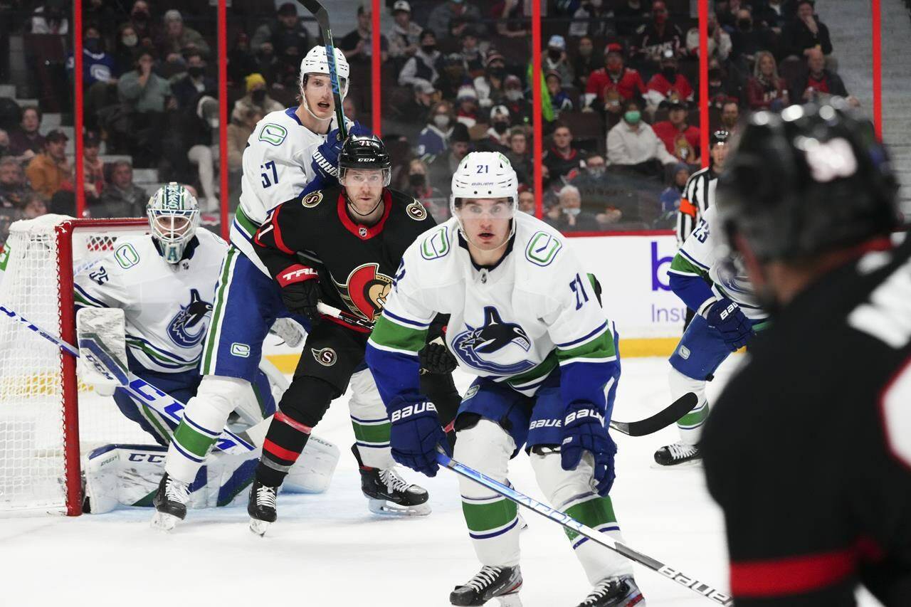 Vancouver Canucks goaltender Thatcher Demko (35) looks on as teammate Tyler Myers (57) battles with Ottawa Senators’ Chris Tierney (71) as Nils Hoglander (21) anticipates a shot on net during second period NHL action in Ottawa on Wednesday, Dec. 1, 2021. THE CANADIAN PRESS/Sean Kilpatrick