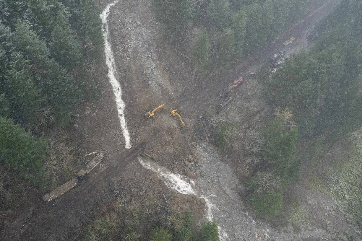 A  locomotive and its cars that were knocked off of the train track by heavy rains and mudslides earlier in the week is pictured in the Fraser Canyon near Hope, B.C., Thursday, November 18, 2021. THE CANADIAN PRESS/Jonathan Hayward