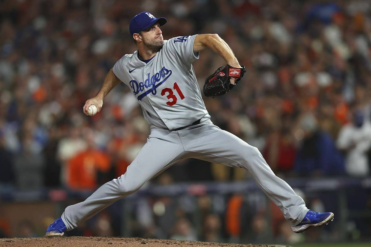 FILE - Los Angeles Dodgers’ Max Scherzer pitches against the San Francisco Giants during the ninth inning of Game 5 of a baseball National League Division Series Thursday, Oct. 14, 2021, in San Francisco. Eight-time All-Star Max Scherzer is nearing a $130 million, three-year contract with the New York Mets, a person familiar with the negotiations told The Associated Press. The person spoke on condition of anonymity Monday, Nov. 29, because the agreement was still being worked on and would be subject to a successful physical.(AP Photo/John Hefti, File)