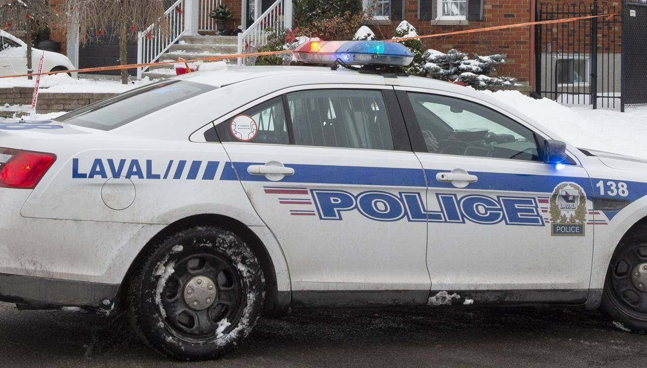 Police investigate a crime scene at a home in Laval, Que., Monday, Jan. 4, 2021. Laval police say they've arrested a 42-year-old man for online threats linked to his support of an conspiracy theorist. THE CANADIAN PRESS/Ryan Remiorz