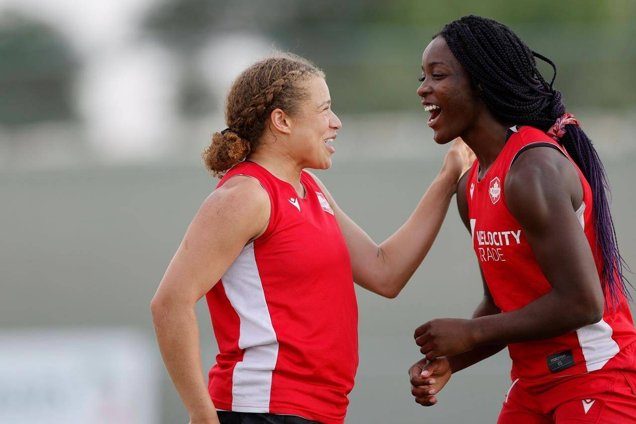 Canada’s Renee Gonzalez, left, and Pamphinette Buisa confer during a training session prior to the Dubai Emirates Airline Rugby Sevens 2021 women’s competition, in Dubai, U.A.E., in a Nov. 30, 2021, handout photo. THE CANADIAN PRESS/HO-World Rugby-KLC Fotos, Mike Lee, *MANDATORY CREDIT*