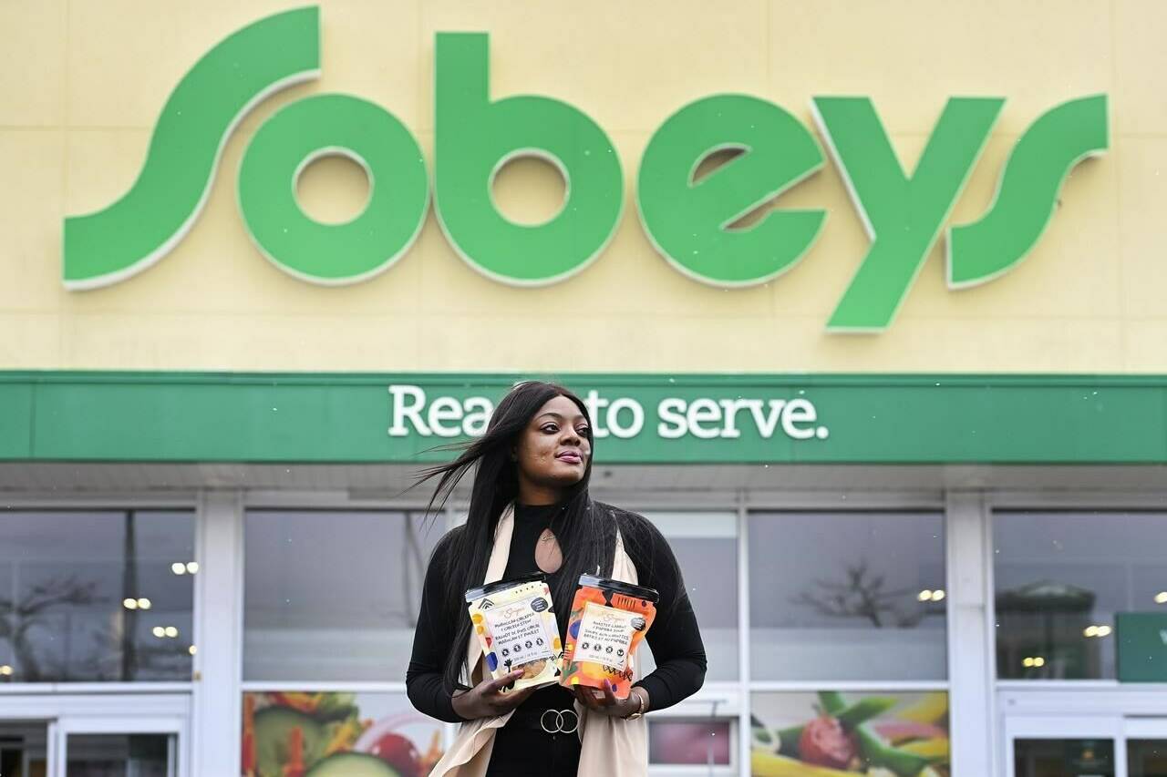 Entrepreneur Lola Adeyemi poses with a few of her African soup products, which are now sold in Canadian grocery retailers, in Toronto on February 5, 2021. THE CANADIAN PRESS/Nathan Denette