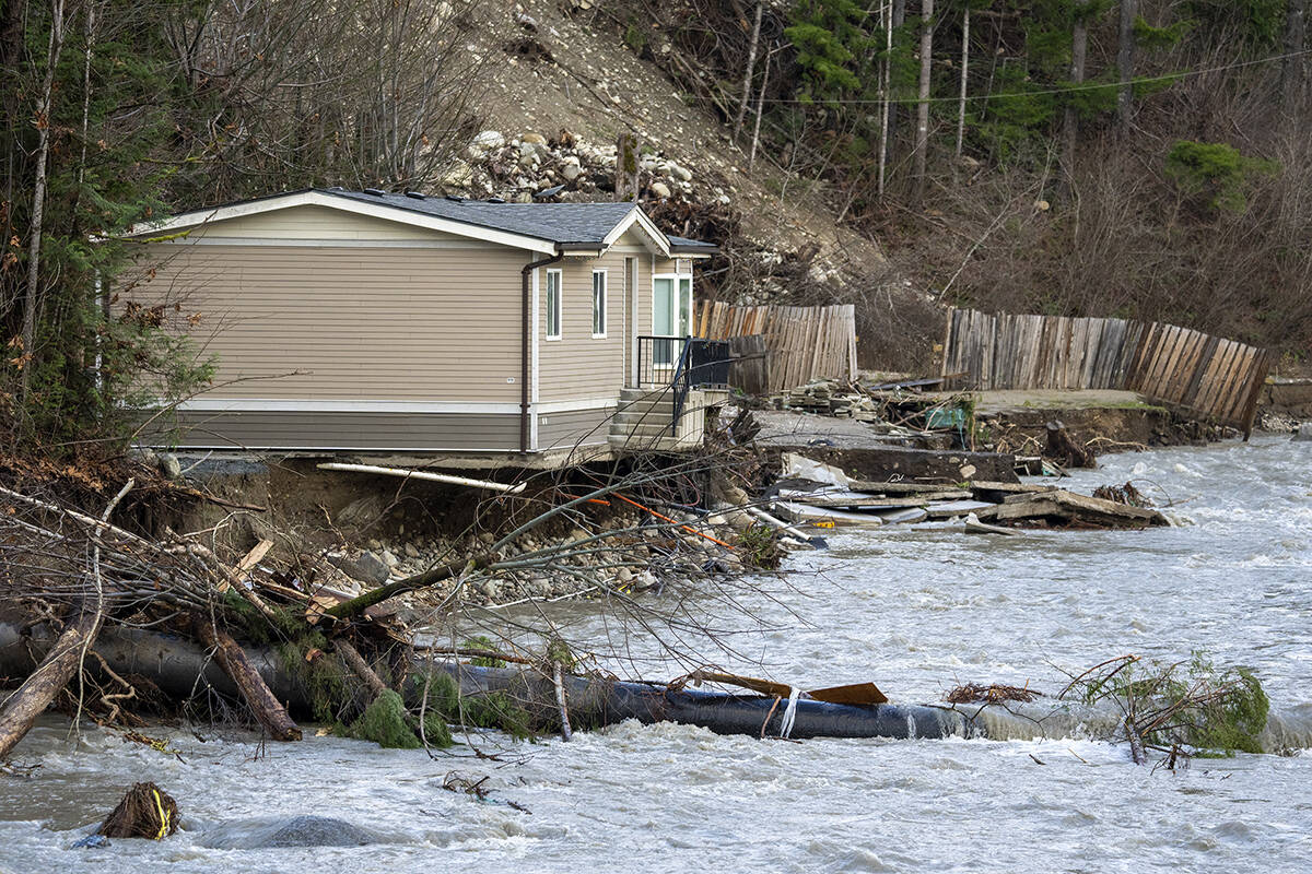 A home has its foundation ripped away by the Coquihalla River near Hope, B.C., Thursday, December 2, 2021. THE CANADIAN PRESS/Jonathan Hayward