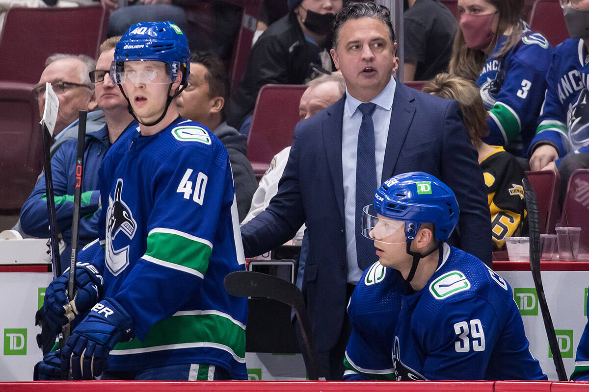 Vancouver Canucks head coach Travis Green stands on the bench behind Elias Pettersson (40), of Sweden, and Alex Chiasson (39) during the third period of an NHL hockey game against the Pittsburgh Penguins in Vancouver, on Saturday, December 4, 2021. THE CANADIAN PRESS/Darryl Dyck