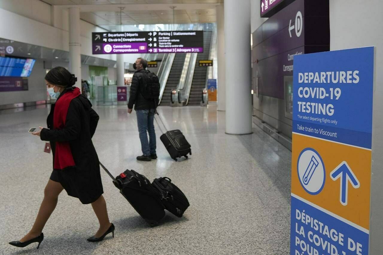 People travel at Pearson International Airport during the COVID-19 pandemic in Toronto, Friday, Dec. 3, 2021. THE CANADIAN PRESS/Nathan Denette