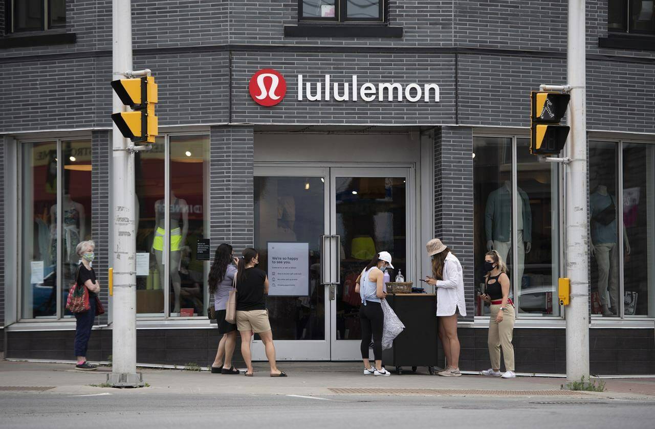 People line up outside a Lululemon Athletica store in Ottawa, as non-essential retail stores re-open with limited in-store capacity, on the first day of Ontario’s first phase of re-opening amidst the third wave of the COVID-19 pandemic, on June 11, 2021. THE CANADIAN PRESS/Justin Tang