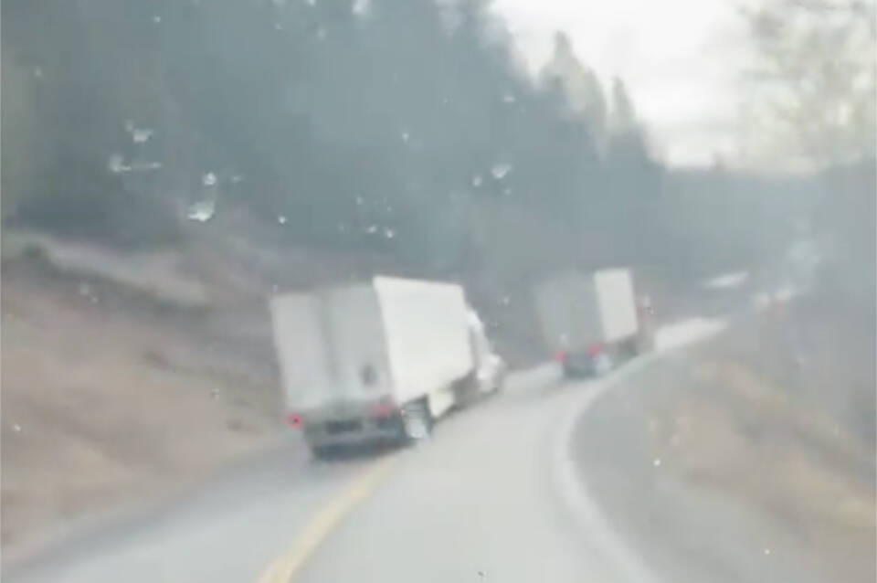 A semi truck was caught on video passing another semi past a double solid line and a curve in the road on Highway 5A on Dec. 2. (Twitter)