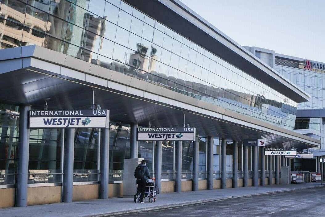 A lone traveler enters the Calgary International Airport on Monday, Feb. 22, 2021. THE CANADIAN PRESS/Jeff McIntosh