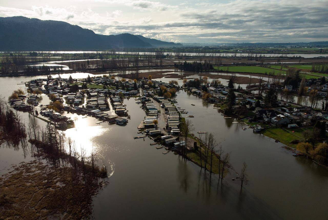 Properties on Hatzic Lake are surrounded by high water after floodwaters began to recede, near Mission, B.C., on Sunday, December 5, 2021. THE CANADIAN PRESS/Darryl Dyck