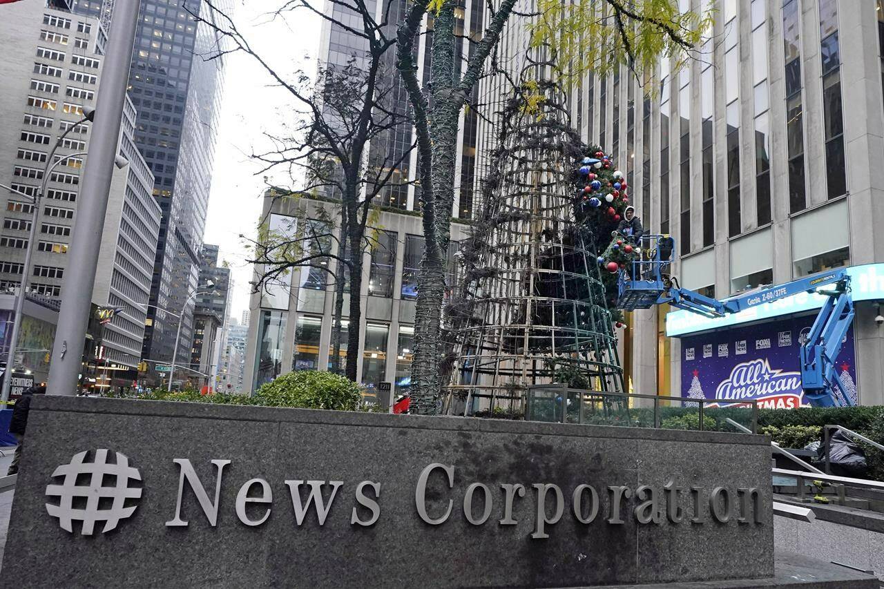 A worker disassembles a Christmas tree outside Fox News headquarters, in New York, Wednesday, Dec. 8, 2021. Police say a man is facing charges including arson for setting fire to a 50-foot Christmas tree in front of Fox News headquarters in midtown Manhattan. The tree outside of the News Corp. building that houses Fox News, The Wall Street Journal and the New York Post caught fire shortly after midnight Wednesday. (AP Photo/Richard Drew)
