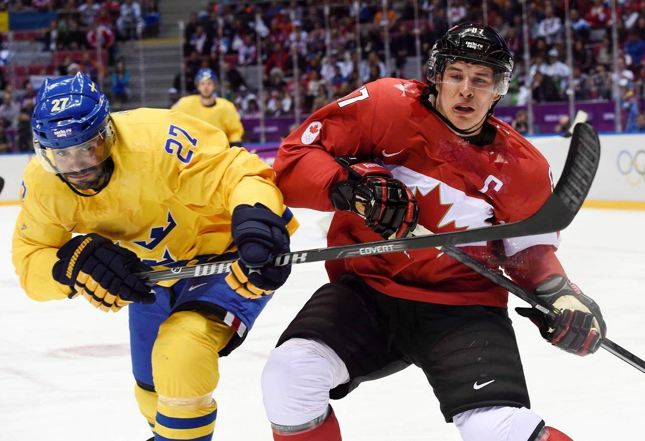 Canada forward Sidney Crosby and Sweden defenceman Johnny Oduya rub shoulders during first period men’s gold medal final hockey action at the Sochi Winter Olympics Sunday, February 23, 2014 in Sochi. THE CANADIAN PRESS/Paul Chiasson