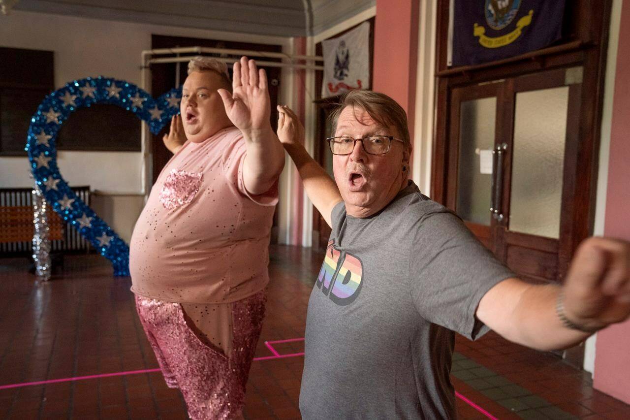This image released by HBO shows Eureka O’Hara, left, and Pastor Craig Duke, of Newburgh, Ind., in a scene from the HBO series “We’re Here.” Duke’s pastoral duties have been terminated – the result of a bitter rift surfacing in his Indiana church after he sought to demonstrate solidarity by appearing in drag alongside prominent drag queens in the reality show. (Jakes Giles Netter/HBO via AP)