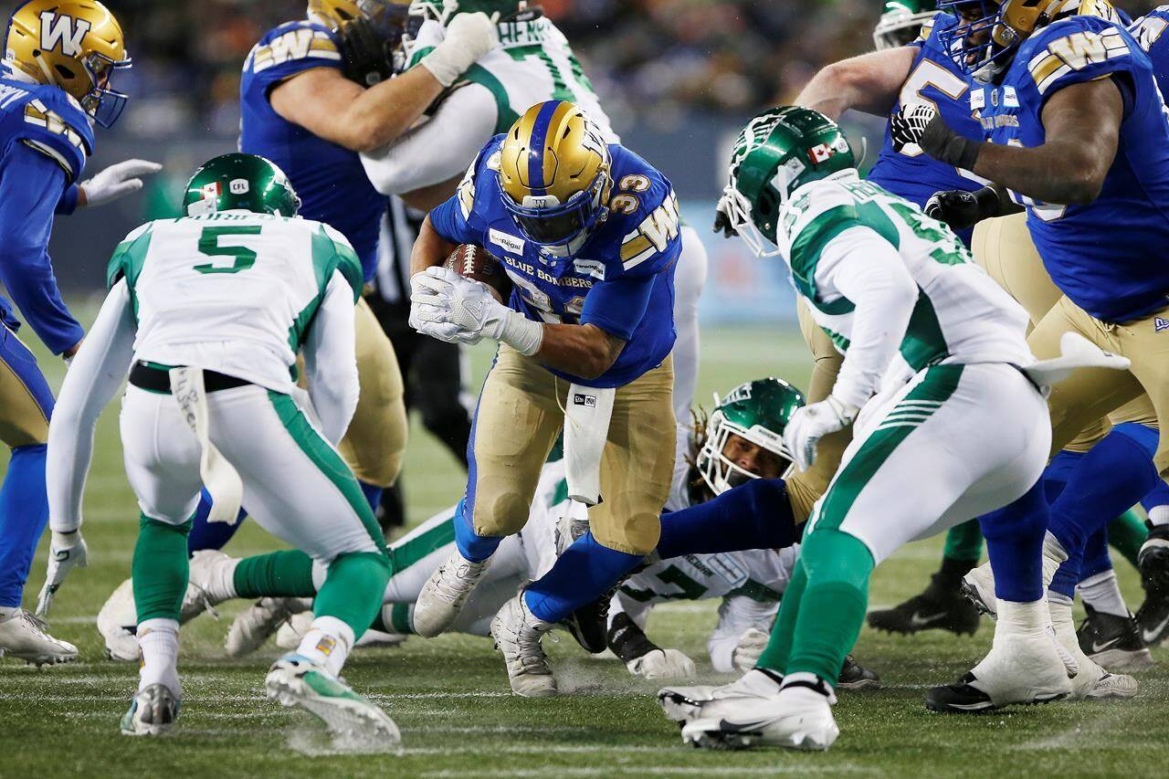 Winnipeg Blue Bombers’ Andrew Harris (33) runs for the first down against the Saskatchewan Roughriders during second half CFL Western final football action in Winnipeg, Sunday, Dec. 5, 2021. THE CANADIAN PRESS/John Woods