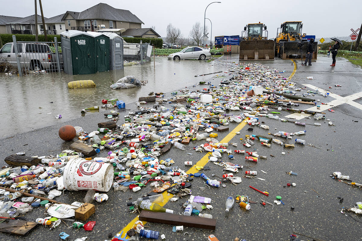 Debris from receding flood waters is pictured along a road as heavy rains form an atmospheric river continue in Abbotsford, B.C., Nov. 30. (THE CANADIAN PRESS/Jonathan Hayward)