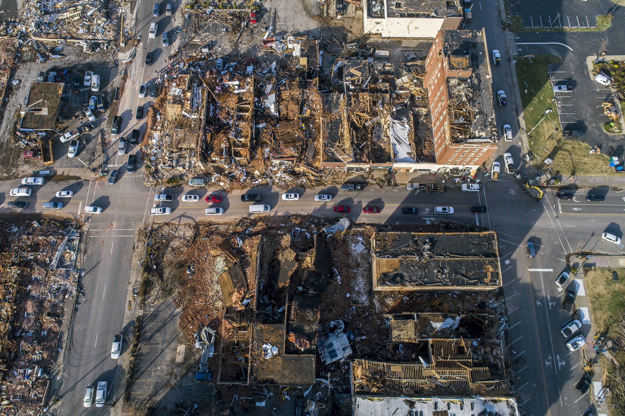 Buildings are demolished in downtown Mayfield, Ky., on Saturday, Dec. 11, 2021, after a tornado traveled through the region Friday night. A monstrous tornado killed dozens of people in Kentucky and the toll was climbing Saturday after severe weather ripped through at least five states, leaving widespread devastation. (Ryan C. Hermens/Lexington Herald-Leader via AP)