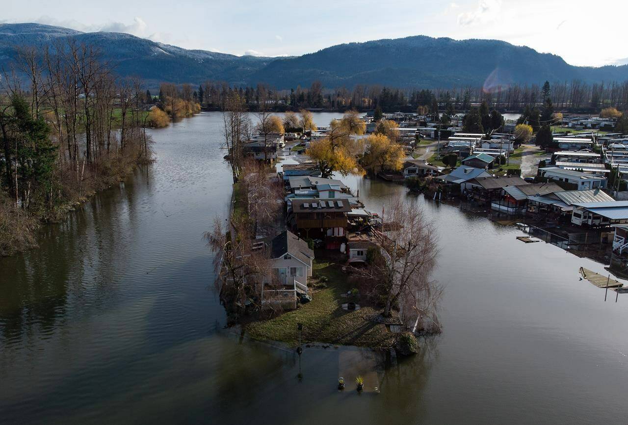 Properties are surrounded by high water after floodwaters began to recede at Everglades Resort on Hatzic Lake near Mission, B.C., Sunday, Dec. 5, 2021. Parts of British Columbia’s tourism industry are facing another uphill battle with an uncertain recovery horizon after this year’s damaging storms.THE CANADIAN PRESS/Darryl Dyck