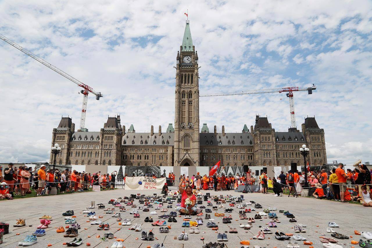 Jane Kigutaq, a kindergarten teacher from Arctic Bay now living in Ottawa, protests on Parliament Hill at a “Cancel Canada Day” event in response to the discovery of unmarked indigenous graves at residential schools on July 1, 2021. THE CANADIAN PRESS/Patrick Doyle