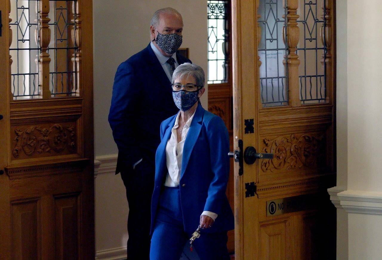B.C. finance minister Selina Robinson leaves the assembly with Premier John Horgan after the budget speech in the legislative assembly at the provincial legislature in Victoria, Tuesday, April 20, 2021. Finance Minister Selina Robinson says the federal government's $5 billion contribution to flood disaster recovery efforts in British Columbia is a historic amount of cash that reflects the extreme nature of the disaster. THE CANADIAN PRESS/Chad Hipolito