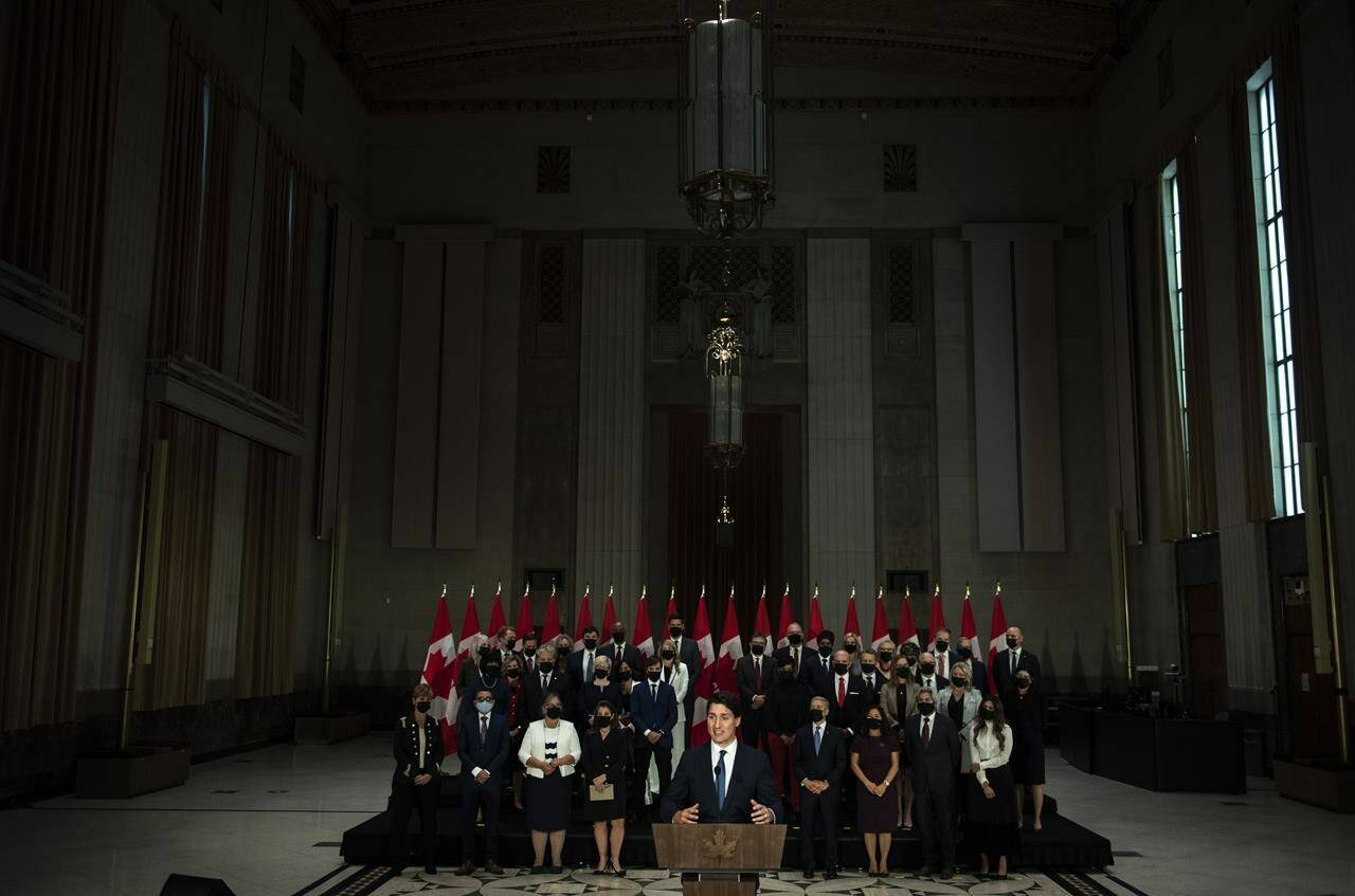 Prime Minister Justin Trudeau stands in front of his newly sworn in federal cabinet during a news conference in Ottawa, on October 26, 2021. THE CANADIAN PRESS/Justin Tang