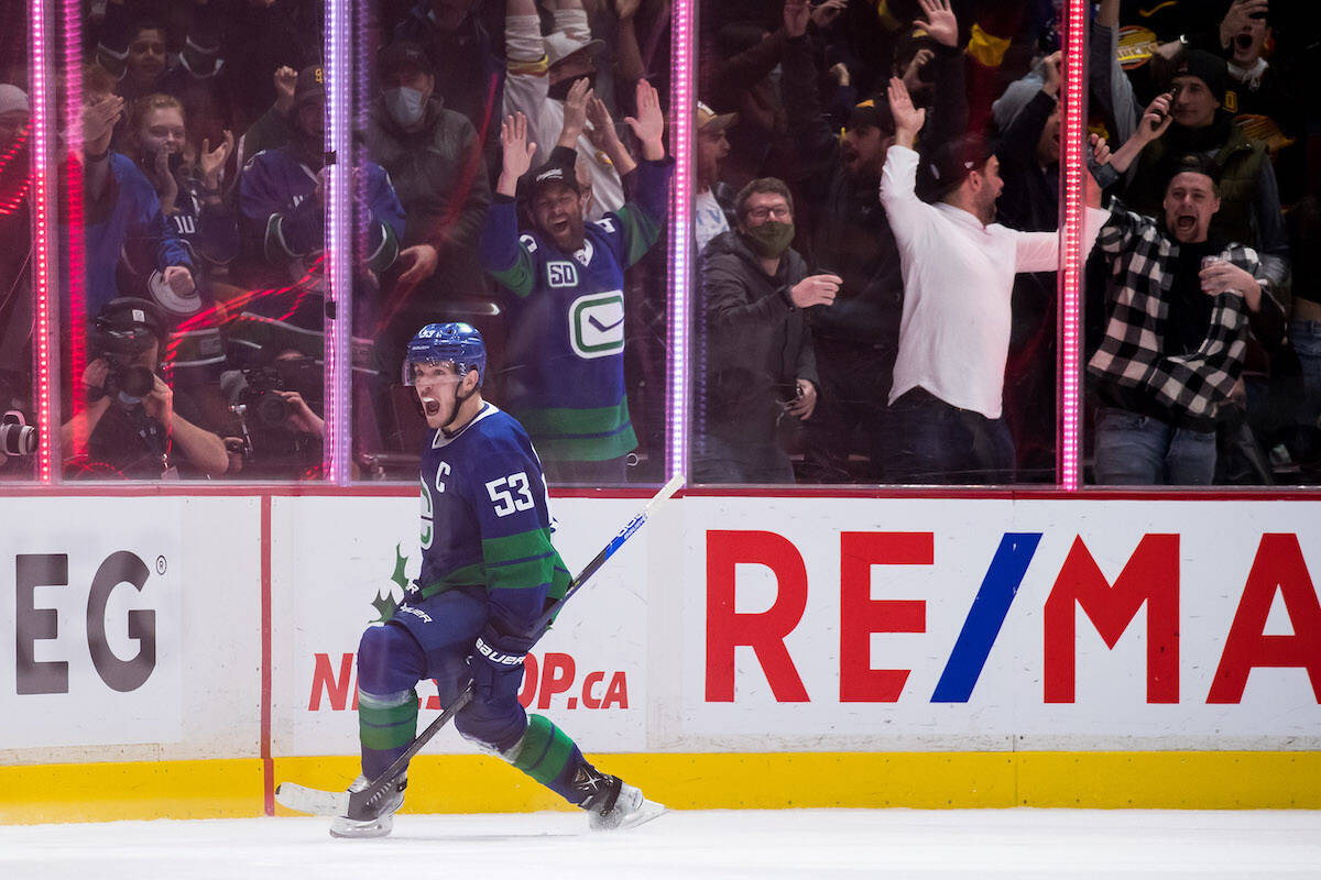 Vancouver Canucks’ Bo Horvat celebrates after scoring the winning goal against the Columbus Blue Jackets, Dec. 14, 2021. Hockey games and other indoor events with more than 1,000 people will be limited to half capacity starting Monday, Dec. 20. (THE CANADIAN PRESS/Darryl Dyck)