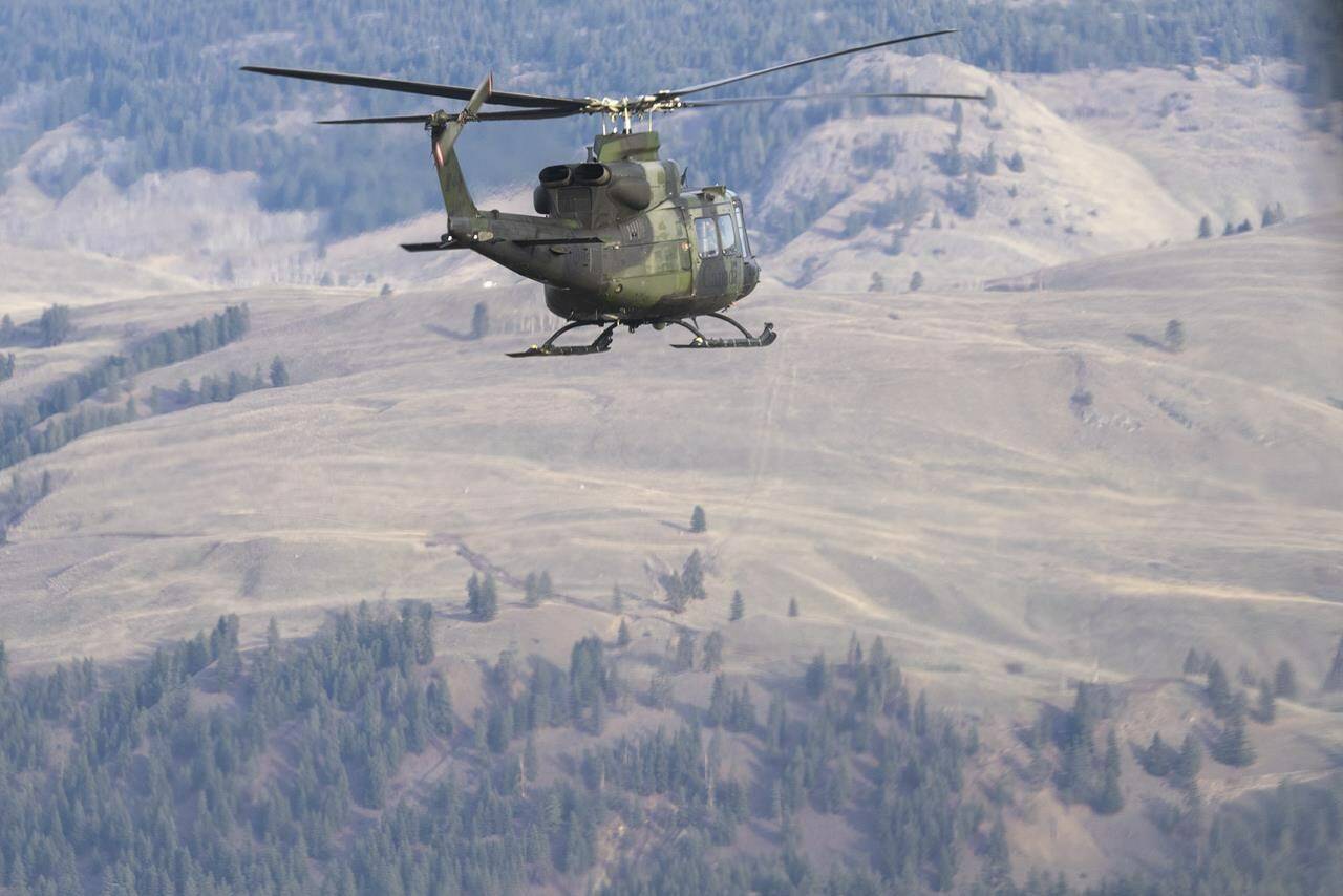 Canadian Forces Griffon helicopters fly over the floods in Princeton, B.C., Friday, Dec. 3, 2021. British Columbia’s public safety minister is thanking Canadian Armed Forces personnel and provincial partners for their assistance responding to communities devastated by flooding. THE CANADIAN PRESS/Jonathan Hayward