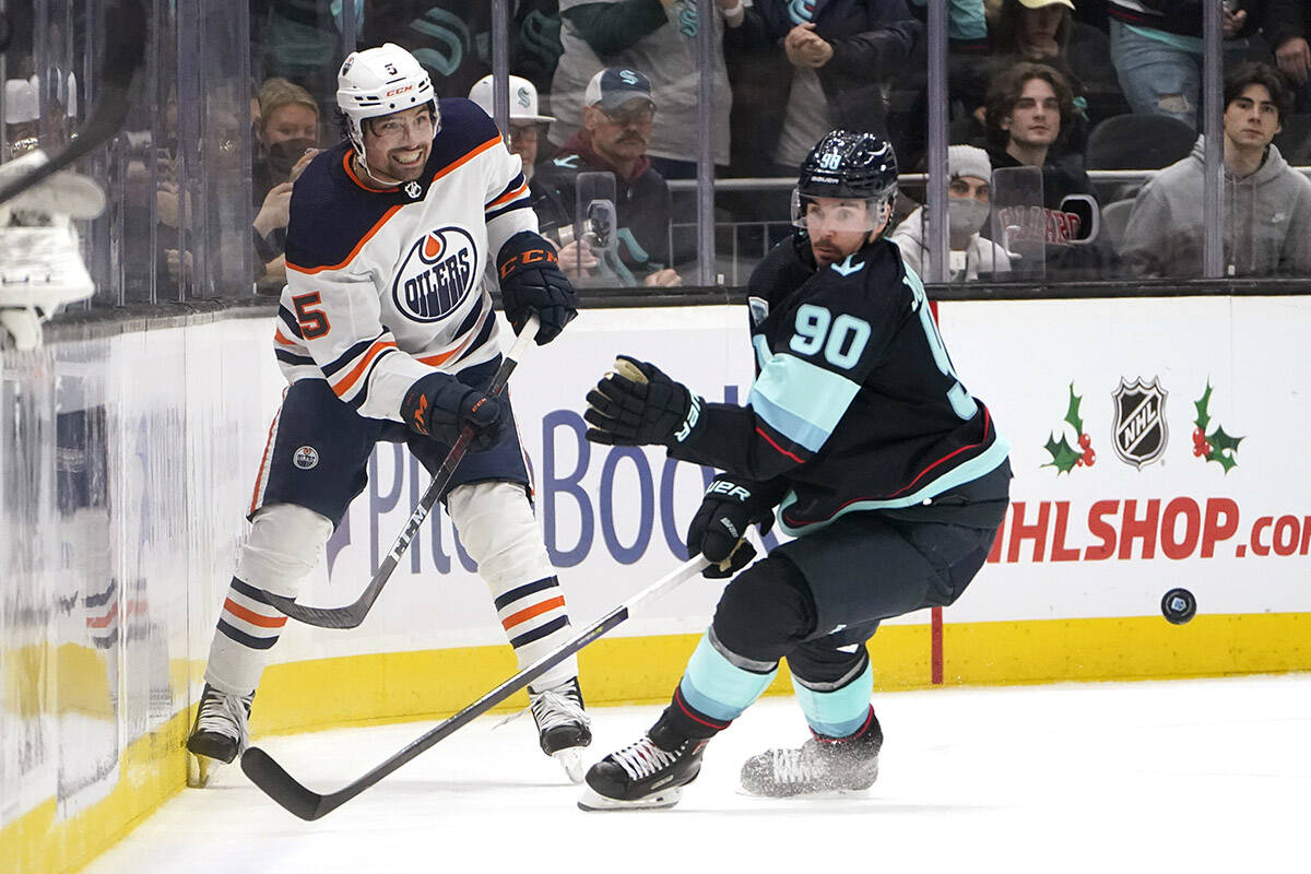 Edmonton Oilers’ Cody Ceci, left, makes a pass in front of Seattle Kraken’s Marcus Johansson (90) in the third period of an NHL hockey game Saturday, Dec. 18, 2021, in Seattle. The Oilers won 5-3. (AP Photo/Elaine Thompson)