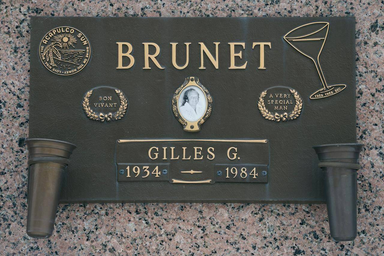 The tombstone of Gilles Brunet is seen in a Montreal cemetery on Friday, December 10, 2021. THE CANADIAN PRESS/Paul Chiasson