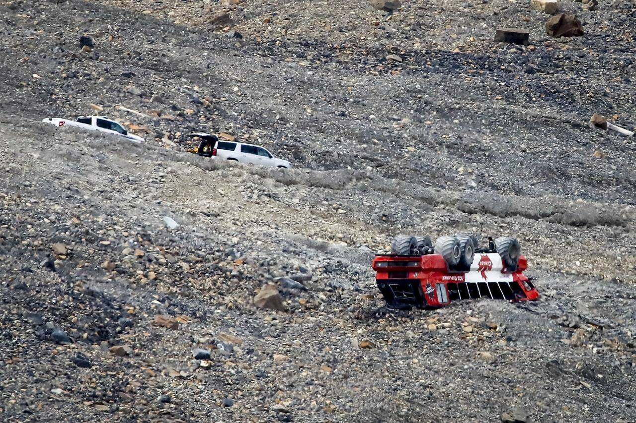 RCMP attend the scene of a sightseeing bus rollover at the Columbia Icefields near Jasper, Alta., on July 19, 2020. A man who lost his wife when an all-terrain tour bus rolled at the Columbia Icefield in the Rocky Mountains is pressing the RCMP for answers about what happened. Three people were killed and 14 others had life-threatening injuries on July 18, 2020, when the red-and-white Ice Explorer lost control on the road to the Athabasca Glacier, about 100 kilometres southeast of Jasper, Alta. THE CANADIAN PRESS/Jeff McIntosh