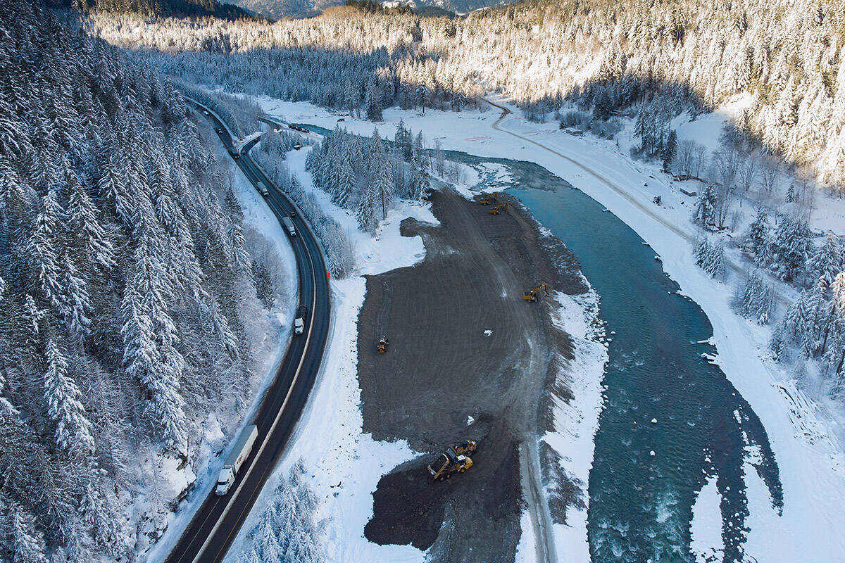 Transport trucks hauling trailers travel on the Coquihalla Highway after it was reopened to commercial traffic as heavy equipment is used to rebuild the southbound lanes that were washed away by flooding last month at Othello, northeast of Hope, B.C., on Monday, December 20, 2021. THE CANADIAN PRESS/Darryl Dyck