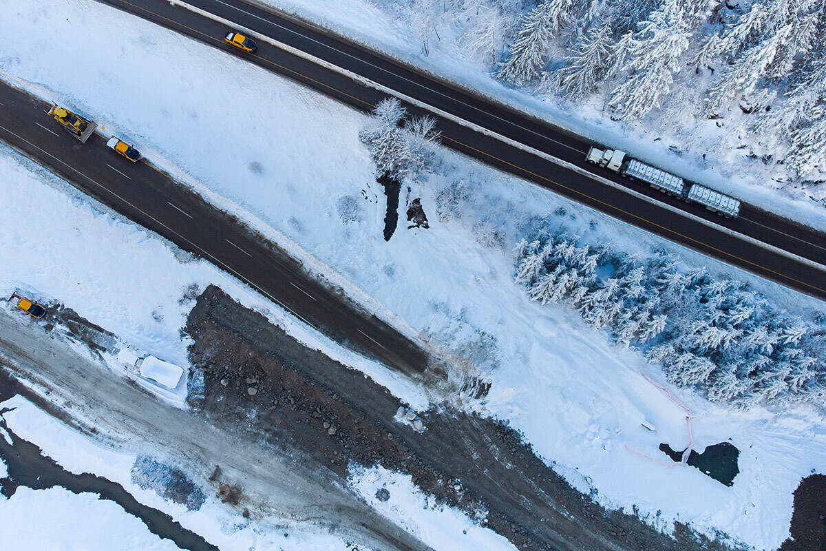 A transport truck hauling a trailer travels on the Coquihalla Highway after it was reopened to commercial traffic as work continues to rebuild the southbound lanes that were washed away by flooding last month at Othello, northeast of Hope, B.C., on Monday, December 20, 2021. THE CANADIAN PRESS/Darryl Dyck