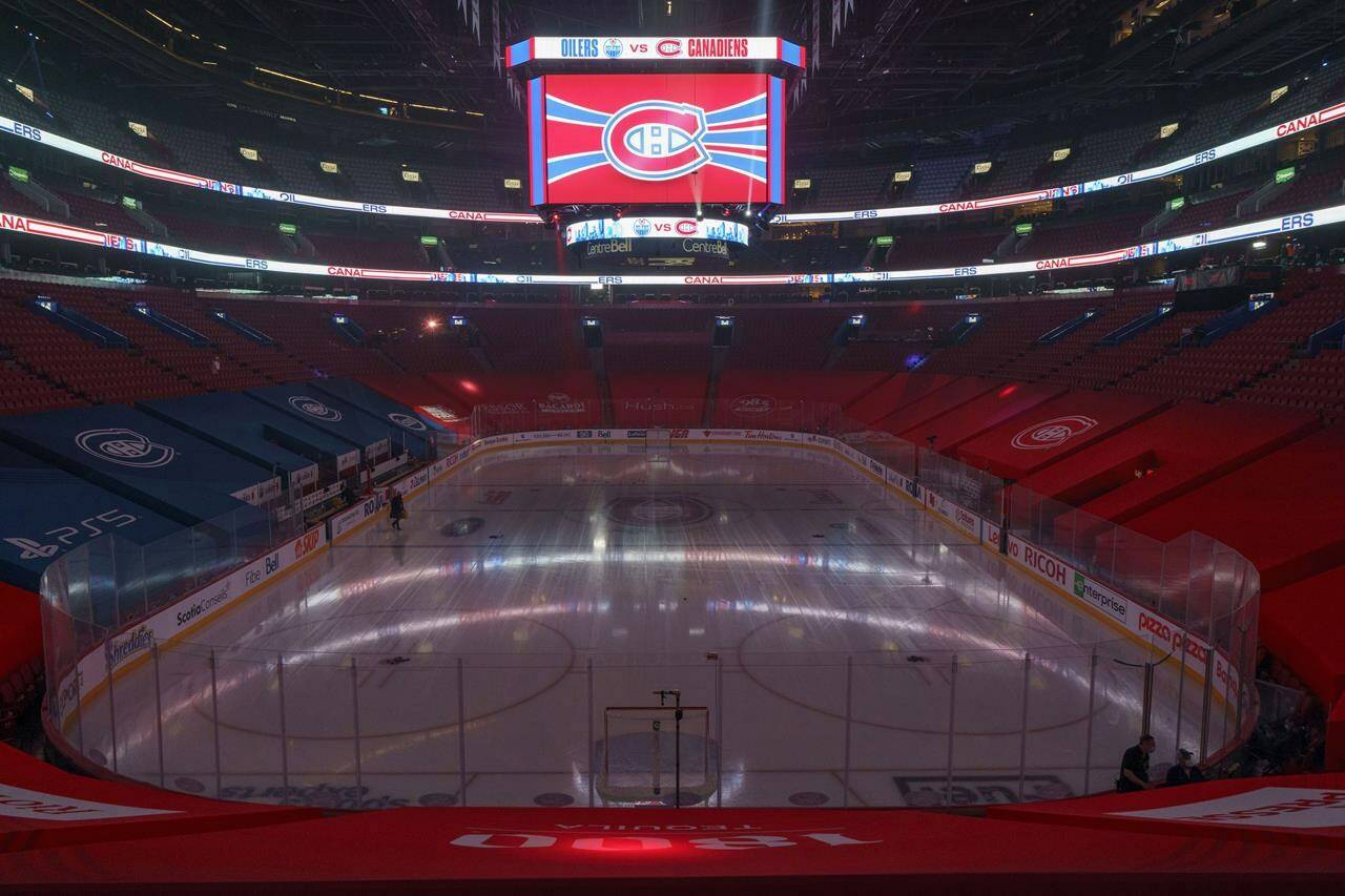 The clock at the Bell Centre shows graphics before the postponement of an NHL hockey game between the Montreal Canadiens and the Edmonton Oilers, in Montreal on March 22, 2021. THE CANADIAN PRESS/Paul Chiasson