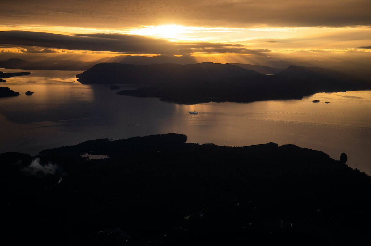 The B.C. Ferries vessel Spirit of British Columbia passes Salt Spring Island while travelling on the Salish Sea from Tsawwassen to Swartz Bay, B.C., at sunset on Sunday, October 3, 2021. THE CANADIAN PRESS/Darryl Dyck