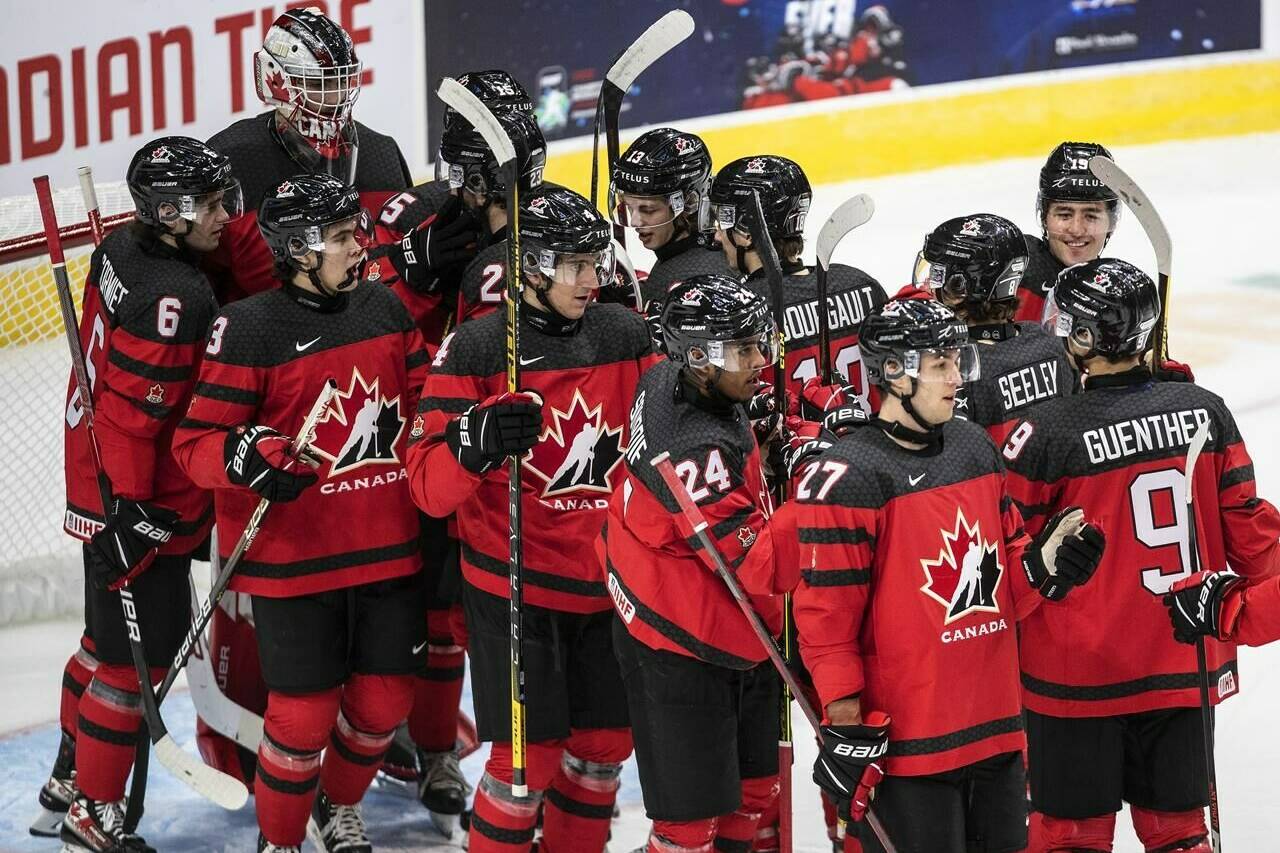 Canada celebrates the win over Russia at the end of IIHF World Junior Hockey Championship exhibition action in Edmonton, Thursday, Dec. 23, 2021. THE CANADIAN PRESS/Jason Franson