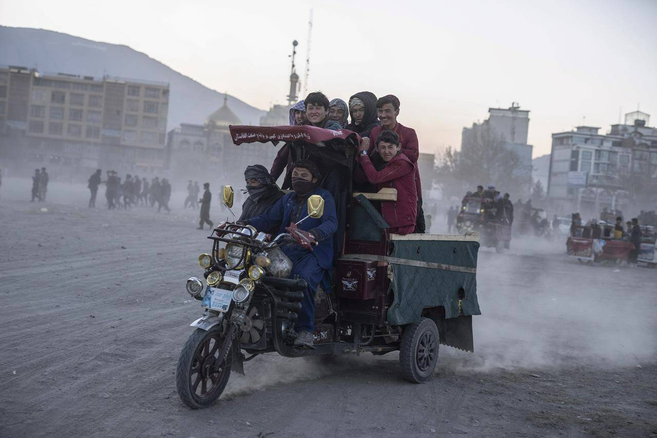 People ride on a three-wheel vehicle in Kabul, Afghanistan, Friday, Nov. 19 , 2021. THE CANADIAN PRESS/AP/Petros Giannakouris