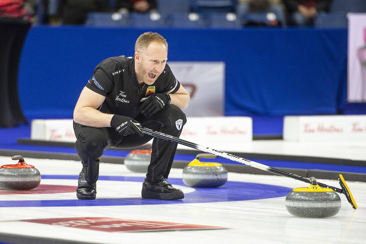 Team Jacobs skip, Brad Jacobs encourages sweepers as a rock glides towards the rings during men’s final of the 2021 Canadian Olympic curling trials against Team Gushue, in Saskatoon, Sask., Sunday, Nov. 28, 2021. THE CANADIAN PRESS/Rick Elvin